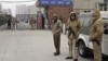 Indian police officers stand outside the district court where five men accused in a gang rape were brought to appear in New Delhi, January 7, 2013. 