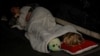 A girl sleeps with her toy as she takes shelter with her family inside a metro station during a Russian military attack in Kyiv, Ukraine, on June 1, 2024.