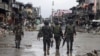 Government troops pass destroyed buildings and houses in Datu Sa Dansalan in Marawi city, southern Philippines, Oct. 17, 2017.
