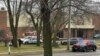 Emergency vehicles are parked outside the Abundant Life Christian School in Madison, Wis., where a shooting occurred, Dec. 16, 2024. A teacher, a student and the shooter were killed, police said.
