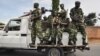 FILE - Burundi's security guards patrol near a polling station for the referendum on a controversial constitutional reform in Bujumbra, Burundi, May 17, 2018. 