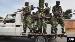 FILE - Burundi's security guards patrol near a polling station for the referendum on a controversial constitutional reform in Bujumbra, Burundi, May 17, 2018. 