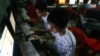 In this Sept. 27, 2012 photo, two Vietnamese students use Facebook at an internet cafe near their dormitory while they could not log in Facebook from their mobile phones because of firewall in Hanoi, Vietnam.