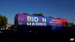 FILE - Then-Democratic presidential candidate former Vice President Joe Biden and then-Democratic vice presidential candidate Sen. Kamala Harris ride on a bus in Phoenix, Arizona, Oct. 8, 2020.