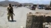 In this picture taken on June 22, 2009, a Pakistani Frontier Constabulary soldier stands alert at a checkpost in Tanai village near Wana, the main town of South Waziristan. The residents of South Waziristan say troops are massing on their doorstep, food i