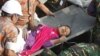 Bangladeshi rescuers retrieve garment worker Reshma from the rubble of a collapsed building in Savar on May 10, 2013.