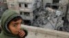 FILE - A Palestinian boy reacts near the site of an Israeli strike on a house in Rafah, Gaza Strip, March 24, 2024. Children in war zones around the world are not receiving lifesaving humanitarian aid, a senior U.N. official said on April 3, 2024.
