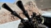 FILE - fighters with the Free Syrian army patrol the outskirts of the northern town of Jisr al-Shughur, Syria, west of the city of Idlib.