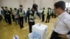 A South Korean police officer casts his early vote for the upcoming May 9 presidential election at a local polling station in Seoul, South Korea, May 4, 2017. 