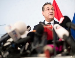 FILE - Austrian Vice Chancellor Heinz-Christian Strache, center, addresses the media during press conference at the sport ministry in Vienna, Austria, May 18, 2019.