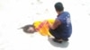UN Migration Agency staff tend to the remains of a deceased migrant on a beach in Yemen.