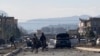 Afghan security personnel gather at the site of an explosion in Kabul, Afghanistan, Nov. 13, 2019. An explosion rocked the Afghan capital as early morning commuters were on the street heading to work.