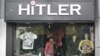 A customer walks out of a garment store named 'Hitler' in the western Indian city of Ahmedabad, September 4, 2012. 