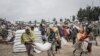 Men carry a sack of wheat during a food distribution by the World Food Programme (WFP) for internally displaced people (IDP) in Debark, 90 kilometers of the city of Gondar, Ethiopia, Sept. 15, 2021.
