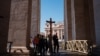 Pilgrims carry a wooden cross at St Peter's square in the Vatican as Pope Francis is still hospitalized with pneumonia on March 06, 2025.