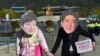 FILE - Protesters wearing masks depicting South Korean President Park Geun-Hye (L) and Japanese Prime Minister Shinzo Abe (R) hold hands during an anti-Japanese rally in Seoul. South Korea President Park Geun-hye and Japanese Prime Minister Shinzo Abe promised to resolve the long-standing dispute over comfort women by year’s end.
