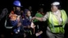 FILE - An unidentified Immigration officer, right, speaks to Nigerian returnees from Libya upon arrival at the Murtala Muhammed International Airport in Lagos Nigeria, Dec. 5, 2017. 