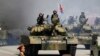 FILE - Soldiers in tanks are paraded across Kim Il Sung Square during a military parade, April 15, 2017, in Pyongyang, North Korea. The United Nations is investigating at least seven African countries accused of receiving military assistance from North Korea.