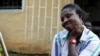 Once forced into prostitution in France, Amaka is now an aspiring businesswoman, selling mens clothes from a bag in the market. (H. Murdock for VOA) 
