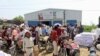 FILE - Yemenis displaced from the port city of Hodeida receive humanitarian aid donated by the World Food Programme (WFP) in the northern province of Hajjah, Sept. 25, 2018.