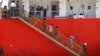 FILE - Afghan migrants walk down the stairway of a tanker that rescued them at a port in Cilegon, Banten province, Indonesia, Apr. 9, 2012. Indonesia said it had rescued 120 Afghan migrants from a leaking wooden ship headed to Australia after receiving a distress call from the ship's captain on Sunday and went to their aid. 