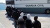 Migrants intercepted aboard a dinghy off the coast in the Strait of Gibraltar, are led into a bus of Spanish civil guard after arriving on a rescue boat at the port of Tarifa, southern Spain, June 29, 2018. 