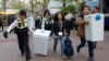 South Korean National Election Commission officials and police officers carry boxes containing ballots for parliamentary election as they arrive at a ballot counting office in Seoul, South Korea, April 13, 2016. 