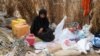 FILE - A Yemeni woman sits in the remains of a home in a neighborhood ravaged by Tropical Cyclone Sagar, in the port city of Hodeidah, Yemen, May 19, 2018. Tropical Cyclone Luban devastated the southeastern coast of Yemen earlier this week.