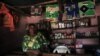 A Congolese woman stands inside her cosmetic shop in Bunagana near the Uganda-Democratic Republic of Congo border, July 9, 2012. 