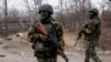 FILE - Ukrainian servicemen patrol their position next a bridge over the river Siverskiy Donets damaged by explosions during a fighting between Pro-Russian rebels and Ukrainian government forces near Trehizbenka village, Luhansk region eastern Ukraine.