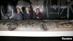 FILE - U.S. Vice President Mike Pence, center, observes a life-size replica of an Australian saltwater crocodile during his visit to the Australian Museum with Australian Foreign Minister Julie Bishop, left, and the museum's Executive Director Kim McKay in Sydney, Australia, April 22, 2017.