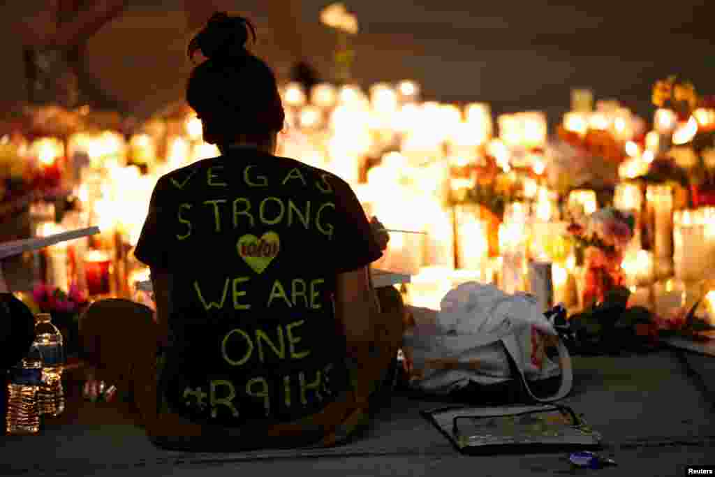 People gather and light candles to honor soccer legend Diego Maradona, at the popular "Quartieri Spagnoli" neighborhood, in Naples, Italy.
