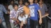 People rescue an injured person after a bomb blast in Hyderabad, India, Feb. 21, 2013.