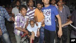 People rescue an injured person after a bomb blast in Hyderabad, India, Feb. 21, 2013. 