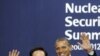 South Korea's President Lee Myung-bak (L) poses with U.S. President Barack Obama as he arrives for a working dinner at the Nuclear Security Summit at the Convention and Exhibition Center in Seoul, March 26, 2012.