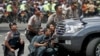 Police officers react near the site of a blast in Jakarta, Indonesia, January 14, 2016. Several explosions went off and gunfire broke out in the centre of the Indonesian capital on Thursday and police said they suspected a suicide bomber was responsible f