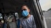 Un hombre usa una máscara contra la propagación de la enfermedad COVID-19, mientras viaja en un autobús a su casa en Managua, Nicaragua, el lunes 11 de mayo de 2020.