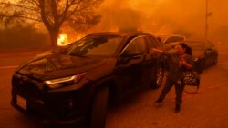 Residentes de Los Ángeles huyen ante el avance de incendio avivado por el viento
