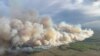 This aerial handout picture courtesy of the Alberta Wildfire Service, taken May 10, 2024, shows smoke from wildfires burning in the Grande prairie forest area, 4 kilometers east of the town of Teepee Creek, in Alberta, Canada.