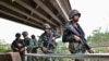 Thai military personnel stand guard overlooking the Moei river on the Thai side, near the Tak border checkpoint with Myanmar, in Thailand's Mae Sot district on April 10, 2024.
