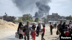 El humo se eleva tras un ataque israelí mientras los palestinos desplazados huyen de zonas del este de Khan Younis tras una orden de evacuación israelí, en medio del conflicto en curso entre Israel y Hamás, en Khan Younis, en el sur de la Franja de Gaza, el 7 de octubre de 2024. 