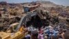 FILE - rescuers work at the scene of a garbage landslide, on the outskirts of the capital Addis Ababa, in Ethiopia. 