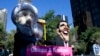 Members of international advocacy group Avaaz take part in a protest wearing masks outside the U.N. headquarters in New York. September 24, 2013. 