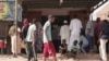 FILE - People line up in front of a bakery during a cease-fire in Khartoum, Sudan, May 27, 2023. Cholera is spreading in Sudan, killing at least 388 people and sickening about 13,000 others over the past two months.
