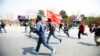 Members of a splinter faction of the Unified Communist Party of Nepal Maoist run and shout slogans as they protest against the formation of an interim government in Katmandu, Nepal, March 14, 2013.