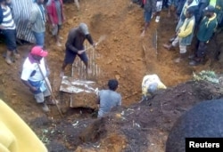 Locals dig for bodies after a house was covered by a landslide in the town of Mendi after an earthquake struck Papua New Guinea's Southern Highlands, in this image taken Feb. 27, 2018, obtained from social media.