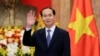 FILE - Vietnamese President Tran Dai Quang greets journalists as he waits for the arrival of Russian Foreign Minister Sergei Lavrov (not pictured) at the Presidential Palace in Hanoi, Vietnam, March 23, 2018.