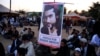 A member of the Pashtun community holds a picture of Naqibullah Mehsud, whose extrajudicial killing by Karachi police sparked nationwide protests, as he gathers with others to protest against what they say are enforced “disappearances” and routine oppress
