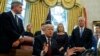 FILE - President Donald Trump answers a reporters question about the investigation of special counsel Robert Mueller during a signing ceremony of the "Cybersecurity and Infrastructure Security Agency Act," in the Oval Office of the White House, Nov. 16, 2018.