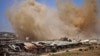FILE - Smoke rises above opposition-held areas of the Daraa province countryside during airstrikes by Syrian regime forces, June 27, 2018.